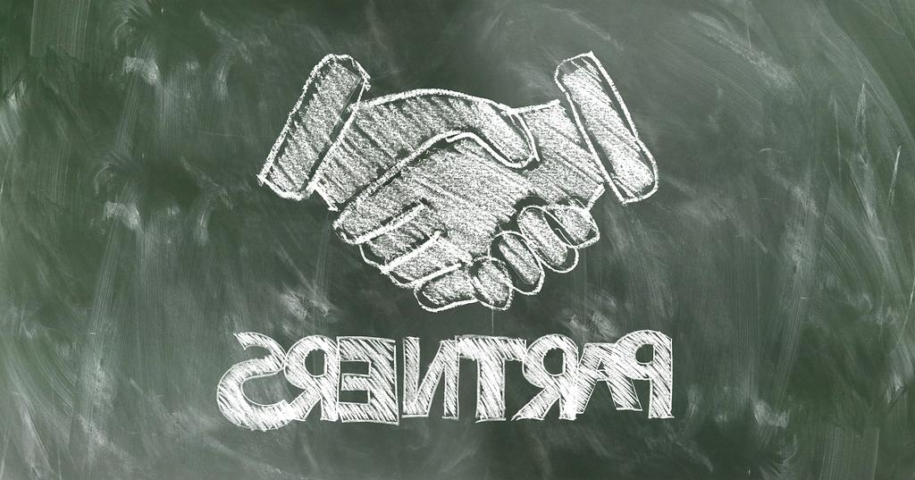 Partnership handshake between Aeris Tech and Global Automotives executives